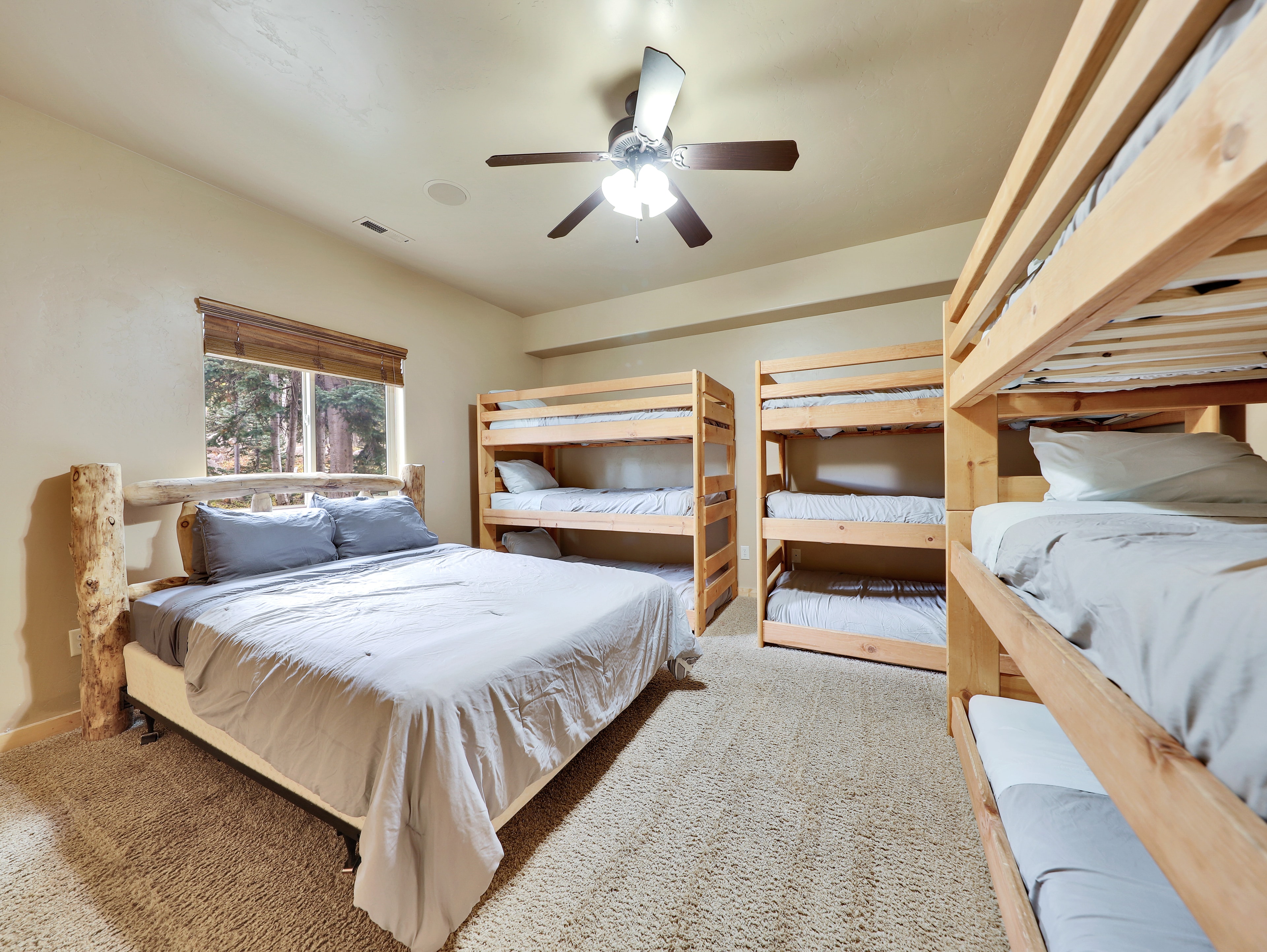 Bunk room with multiple pine bunk beds