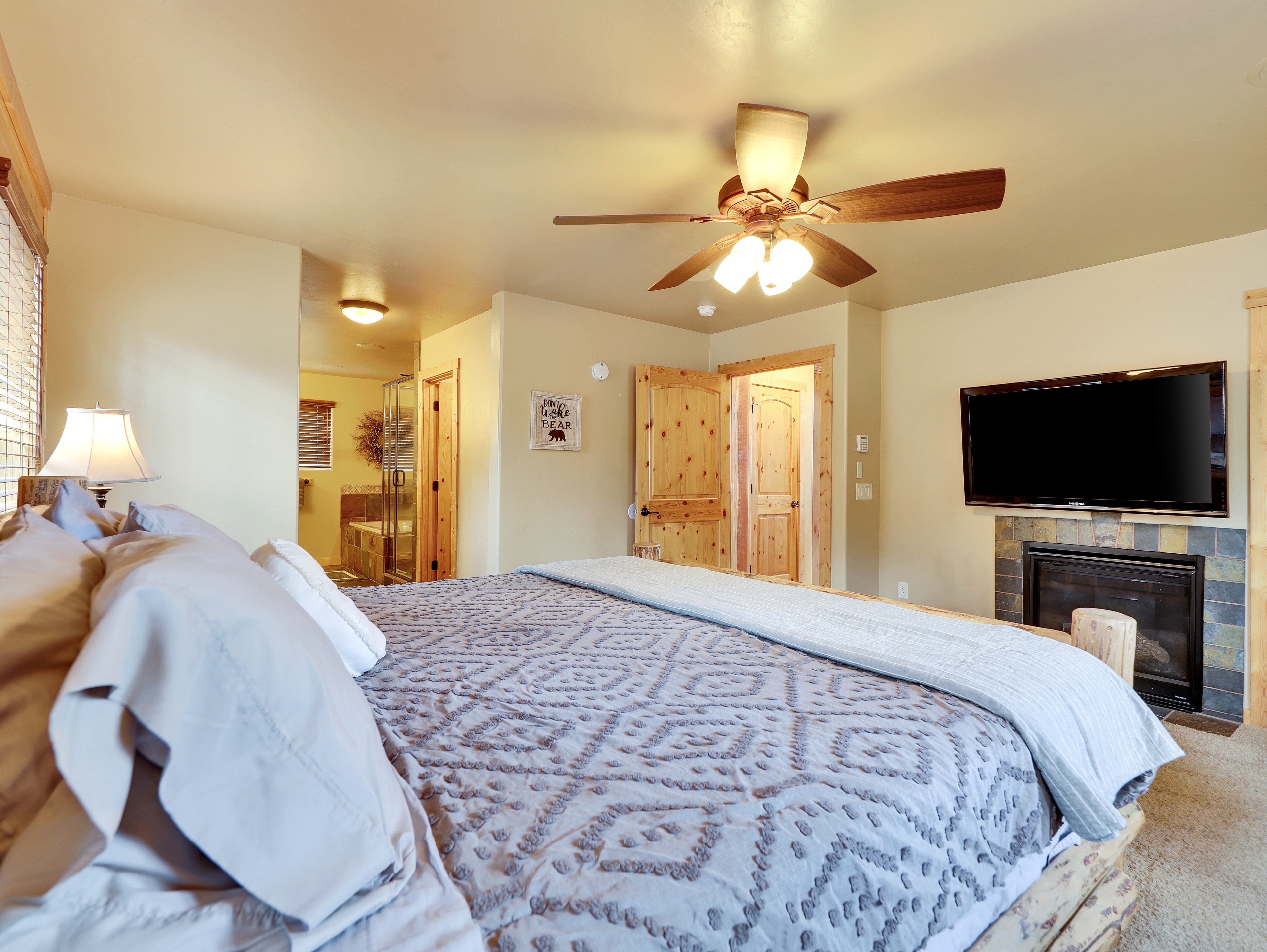 Master suite with fireplace and king bed