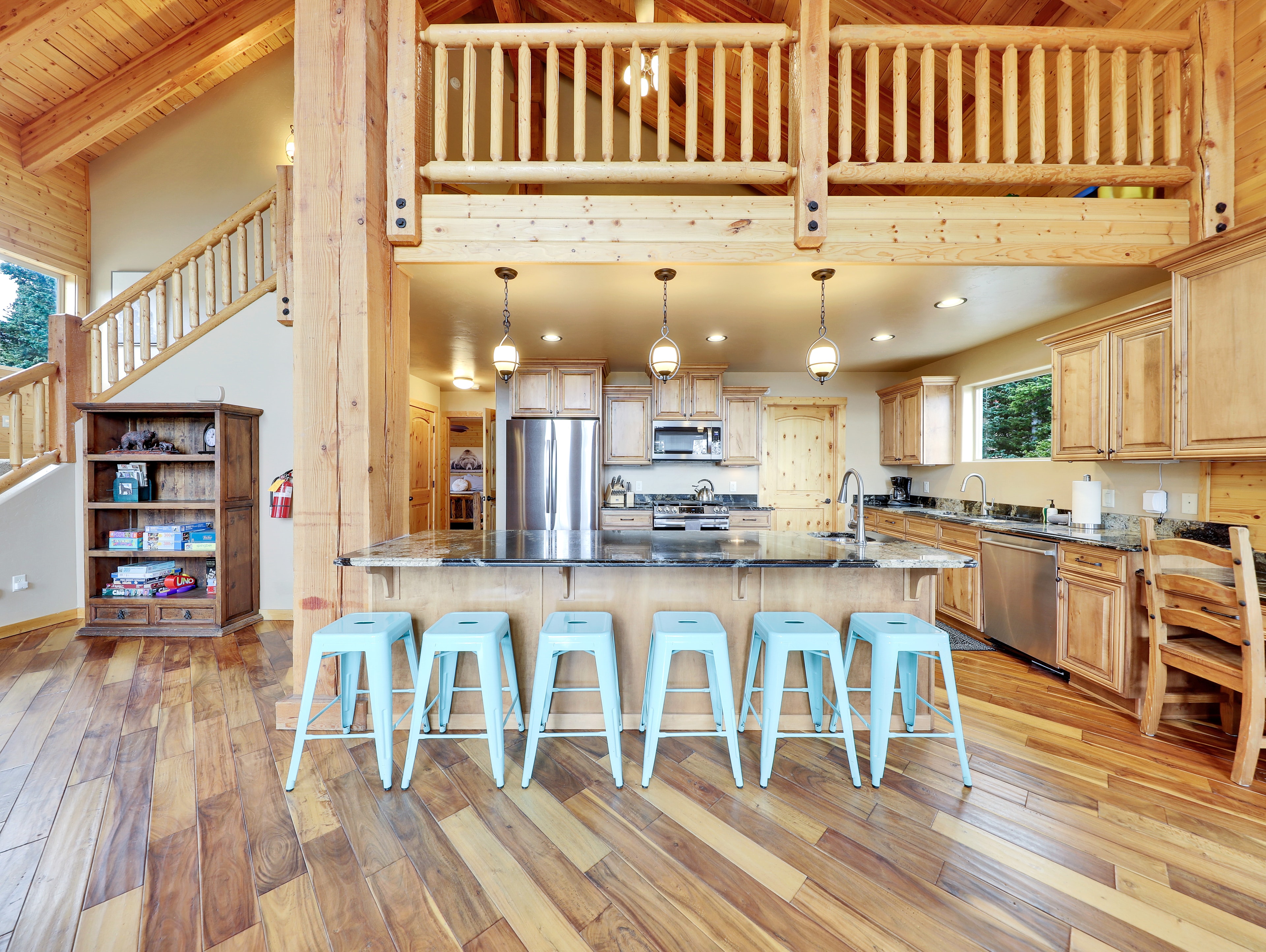 Modern cabin kitchen with blue island stools